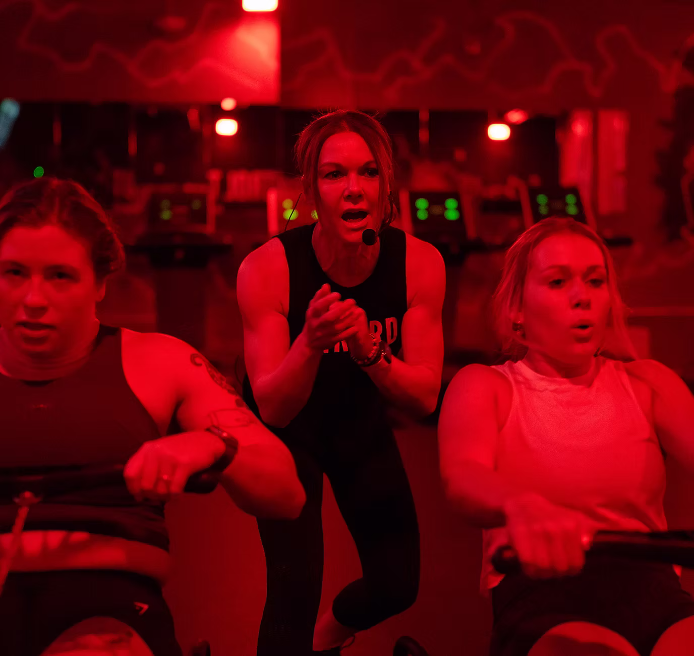 Fitness instructor leading indoor cycling class and NantBioRenewables partnership for sustainable innovation.