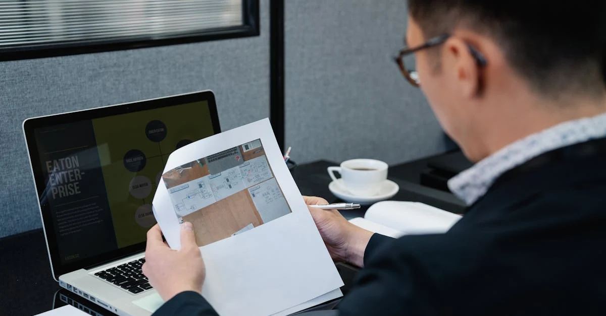 Business professional reviewing order documents at desk with laptop and coffee, demonstrating inventory management.