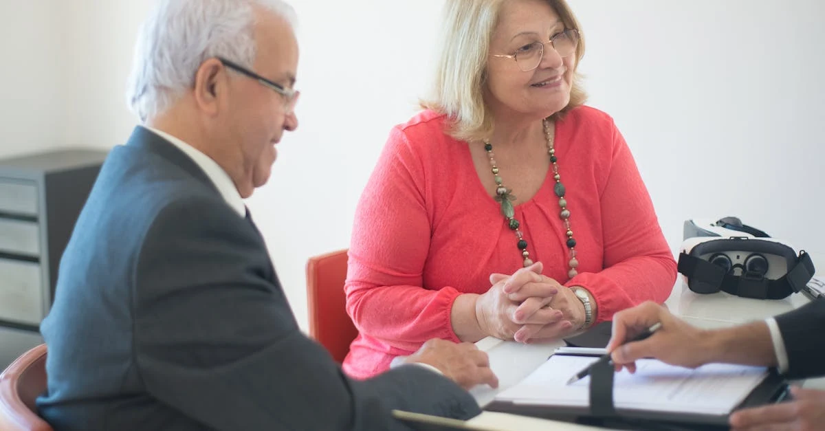 Two professionals discussing selling compostable packaging during business meeting at table with documents.