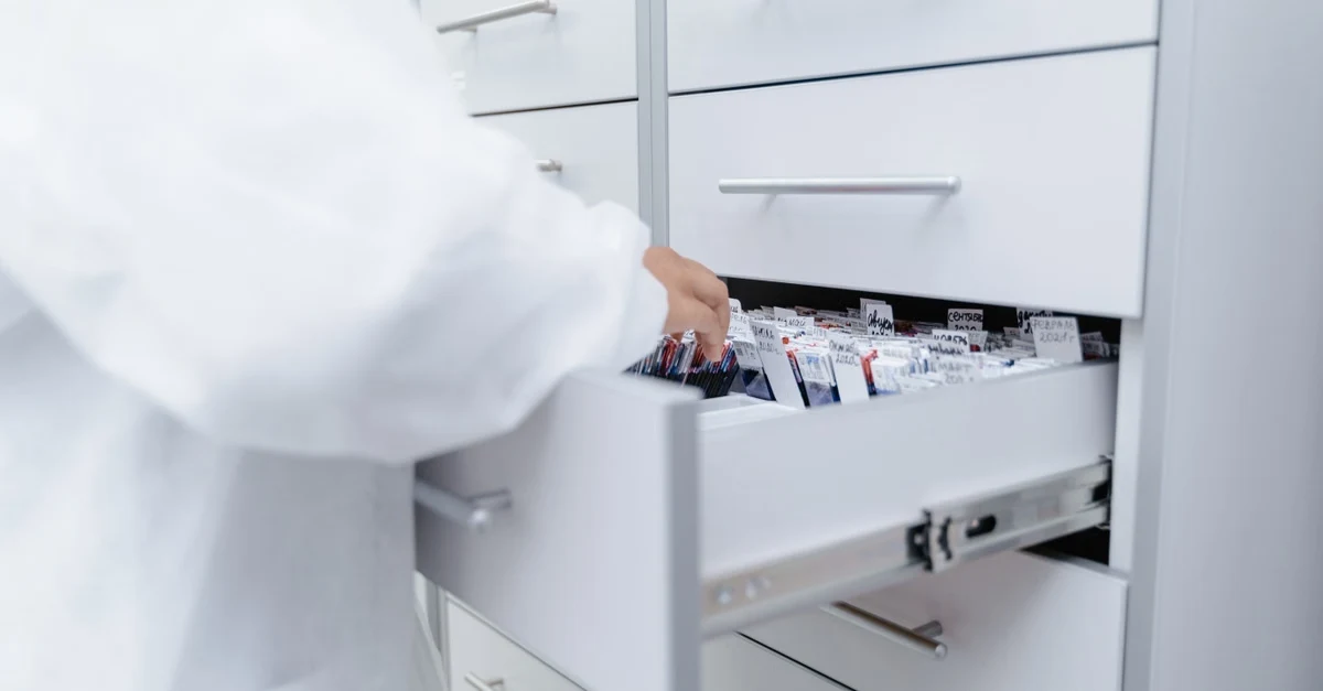 File cabinet drawer open with documents illustrating state-by-state compostable labeling laws and certification requirements.
