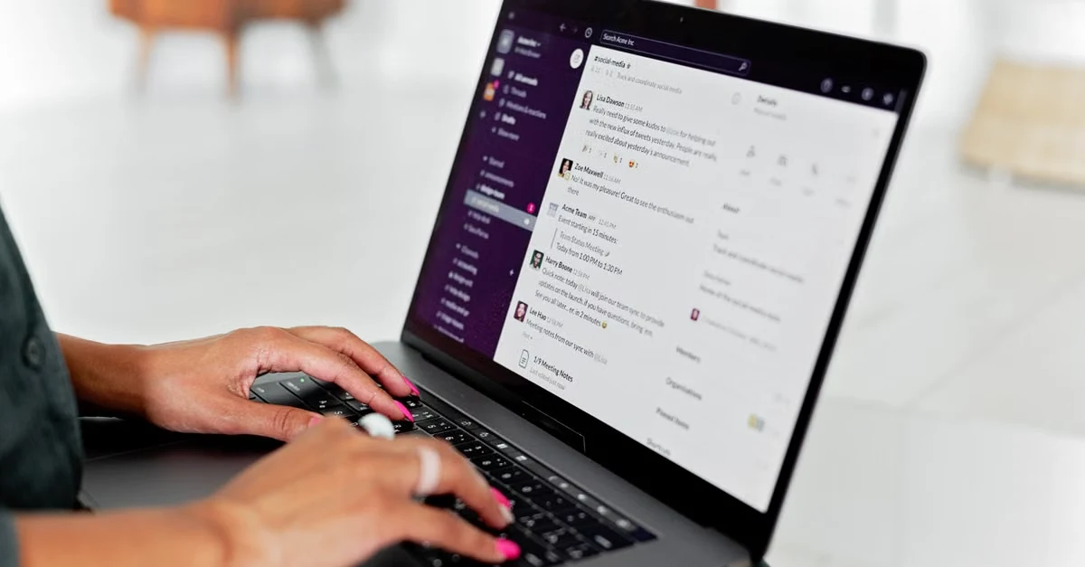 Person using laptop to review supplier certification verification documents on screen with messaging interface visible.